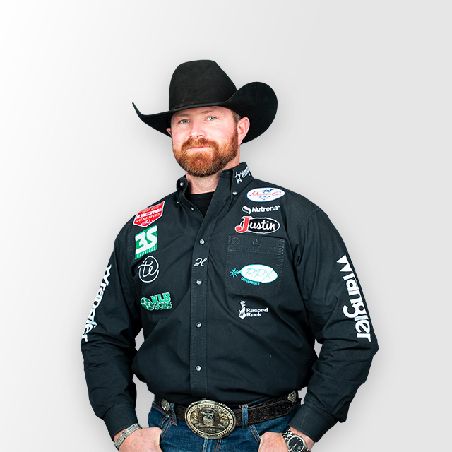 Man wearing a black cowboy hat and black western shirt smiling